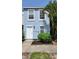 Charming light blue townhouse with white door, neat landscaping and beautiful mature palm trees at 6600 121St Ave # 5, Largo, FL 33773