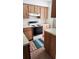Kitchen featuring wooden cabinets, laminate countertops and tile floor at 6600 121St Ave # 5, Largo, FL 33773