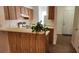Kitchen with breakfast bar area and tile floor leading to entrance area at 6600 121St Ave # 5, Largo, FL 33773