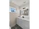 Bathroom featuring a toilet, stylish floors, black faucet and white vanity with modern lighting at 1849 New Hampshire Ne Ave, St Petersburg, FL 33703