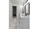 Modern bathroom featuring a double sink vanity, black framed mirrors, and stylish marble-patterned tile floors at 1849 New Hampshire Ne Ave, St Petersburg, FL 33703