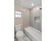 Updated bathroom featuring a bathtub, shower head, and a small window for added light at 1849 New Hampshire Ne Ave, St Petersburg, FL 33703