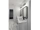 Bathroom featuring double vanity with modern faucets and hardware, decorative lighting, and marble flooring at 1849 New Hampshire Ne Ave, St Petersburg, FL 33703
