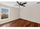 Cozy bedroom featuring wood-look flooring, a modern ceiling fan, and a window allowing natural light at 1849 New Hampshire Ne Ave, St Petersburg, FL 33703