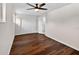 A spacious bedroom with wood-look flooring, double door closet, and a modern ceiling fan with light at 1849 New Hampshire Ne Ave, St Petersburg, FL 33703