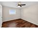 Cozy bedroom featuring hardwood floors, a ceiling fan, a window view, and natural lighting at 1849 New Hampshire Ne Ave, St Petersburg, FL 33703