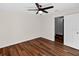 A well-lit bedroom with wood-look flooring, and a modern ceiling fan with light at 1849 New Hampshire Ne Ave, St Petersburg, FL 33703