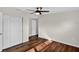Bedroom with wood-look flooring, double closet, a ceiling fan, and connecting ensuite bathroom at 1849 New Hampshire Ne Ave, St Petersburg, FL 33703