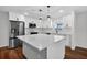 Updated kitchen featuring stainless steel appliances, an island with pendant lighting and quartz countertops at 1849 New Hampshire Ne Ave, St Petersburg, FL 33703