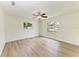 Bright bedroom featuring light wood floors, ceiling fan, and large windows that bring in ample natural light at 221 Vermont E Ave, Bradenton, FL 34208