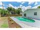 Private backyard featuring a sparkling pool, lush landscaping, and a privacy fence at 221 Vermont E Ave, Bradenton, FL 34208
