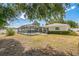This backyard offers a screened pool area, lush landscaping, and a secure white fence at 2521 Carlisle Pl, Sarasota, FL 34231