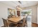 Dining room features a wooden table set with kitchen views and backyard pool access through sliding glass doors at 2521 Carlisle Pl, Sarasota, FL 34231