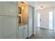 A welcoming foyer featuring tiled flooring, elegant lighting, and convenient built-in storage at 2521 Carlisle Pl, Sarasota, FL 34231