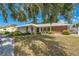 This home has a beautiful lawn with trees and is enhanced with white trim and brick accents at 2521 Carlisle Pl, Sarasota, FL 34231