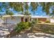 Charming single-story home with brick accents, manicured landscaping, and a two-car garage at 2521 Carlisle Pl, Sarasota, FL 34231