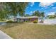 An exterior view of the residence displaying a well-kept lawn and white picket fence at 2521 Carlisle Pl, Sarasota, FL 34231