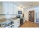 This updated kitchen offers granite countertops, white subway tile backsplash, and stainless steel appliances at 2521 Carlisle Pl, Sarasota, FL 34231