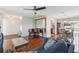 This comfortable living room features hardwood floors, a piano, and seamless transitions to the kitchen and dining areas at 2521 Carlisle Pl, Sarasota, FL 34231
