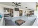 This covered patio is complete with ceiling fans, a TV, a comfortable seating area, and an outdoor dining area at 2521 Carlisle Pl, Sarasota, FL 34231