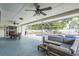 Screened patio boasting a ceiling fan, dining area, comfortable seating, and a view of the inviting swimming pool at 2521 Carlisle Pl, Sarasota, FL 34231