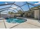 The screened-in pool is surrounded by a concrete patio, with plenty of room for outdoor seating at 2521 Carlisle Pl, Sarasota, FL 34231