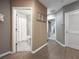 Hallway view into a bathroom with a tub, shower, and toilet at 26835 Juniper Bay Dr, Wesley Chapel, FL 33544
