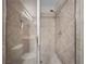 Tiled shower with glass door, dual shower heads, and built-in shelving at 26835 Juniper Bay Dr, Wesley Chapel, FL 33544