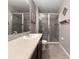 Bathroom featuring tile flooring, a dark vanity with light countertop, and a glass enclosed shower at 26835 Juniper Bay Dr, Wesley Chapel, FL 33544