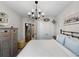 Bedroom featuring neutral walls, ceiling chandelier, and double-door closet at 26835 Juniper Bay Dr, Wesley Chapel, FL 33544