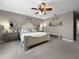 Spacious bedroom featuring a ceiling fan and neutral walls, with a decorative shelf and bench at 26835 Juniper Bay Dr, Wesley Chapel, FL 33544