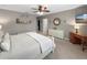 Bedroom featuring neutral walls, a ceiling fan, decorative shelf, dresser, desk, and wall-mounted TV at 26835 Juniper Bay Dr, Wesley Chapel, FL 33544