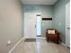 Inviting entryway with decorative accents, a comfortable chair, and tiled floor at 26835 Juniper Bay Dr, Wesley Chapel, FL 33544