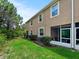 Backyard view of home featuring a cozy screened lanai and well-maintained landscaping at 26835 Juniper Bay Dr, Wesley Chapel, FL 33544
