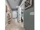 Hallway with tile flooring, decorative wall art, and doorways leading to other rooms at 26835 Juniper Bay Dr, Wesley Chapel, FL 33544