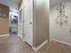 Inviting hallway featuring wood floors, neutral paint, chandelier, and a charming piece of artwork on the wall at 26835 Juniper Bay Dr, Wesley Chapel, FL 33544