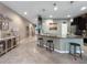 Kitchen island with granite countertops, dark cabinetry, pendant lighting and eat in barstool seating at 26835 Juniper Bay Dr, Wesley Chapel, FL 33544