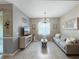 Bright living room with neutral tones, tile flooring, decorative lighting, and comfortable seating arrangement at 26835 Juniper Bay Dr, Wesley Chapel, FL 33544