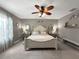 Spacious main bedroom featuring a decorative ceiling fan, accent mirrors, and bench seating at 26835 Juniper Bay Dr, Wesley Chapel, FL 33544