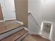 Wooden staircase with white risers and handrail leading up and down at 26835 Juniper Bay Dr, Wesley Chapel, FL 33544
