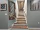A well-lit staircase with decorative artwork on the adjacent wall at 26835 Juniper Bay Dr, Wesley Chapel, FL 33544