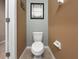 Compact powder room with a toilet, tiled floors, and neutral paint at 26835 Juniper Bay Dr, Wesley Chapel, FL 33544