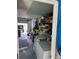 Functional garage space featuring storage shelves, laundry area, and access to the outdoors, providing convenience and utility at 13725 Plumosa Ave, Hudson, FL 34667