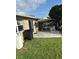 Backyard patio features a small covered area and outdoor seating space at 13725 Plumosa Ave, Hudson, FL 34667