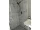 Shower features white marble-like tiling and a handheld shower head, next to a sink at 13725 Plumosa Ave, Hudson, FL 34667