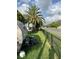 Property includes a yard with a palm tree, utility vehicle, and chain-link fence at 13725 Plumosa Ave, Hudson, FL 34667