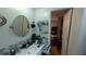 Bathroom with a vanity featuring a large mirror, sink and tiled backsplash adjacent to other rooms in the house at 249 Malvern Dr, Venice, FL 34293