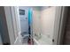 Bathroom featuring a tub with a shower curtain and safety features, offering accessibility and convenience at 249 Malvern Dr, Venice, FL 34293