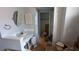A bathroom featuring a sink, mirror, cabinet, and storage space with a door leading to a closet at 249 Malvern Dr, Venice, FL 34293
