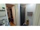 Bathroom featuring a shower, grey shower curtain, storage, and a doorway leading to an adjacent room at 249 Malvern Dr, Venice, FL 34293